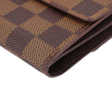 Damier Ebene wallet edge close-up with folded seams and stitched trim.