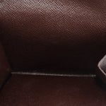 Damier Ebene wallet interior close-up showing fabric lining and compartment seams.