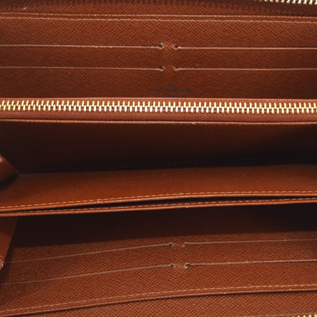 Wallet interior view with brown leather lining and zipper track.