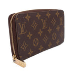 Brown monogram zip-around wallet with gold zipper and side profile view.