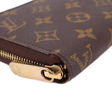 Close-up of monogram wallet zipper pull with gold tone hardware.