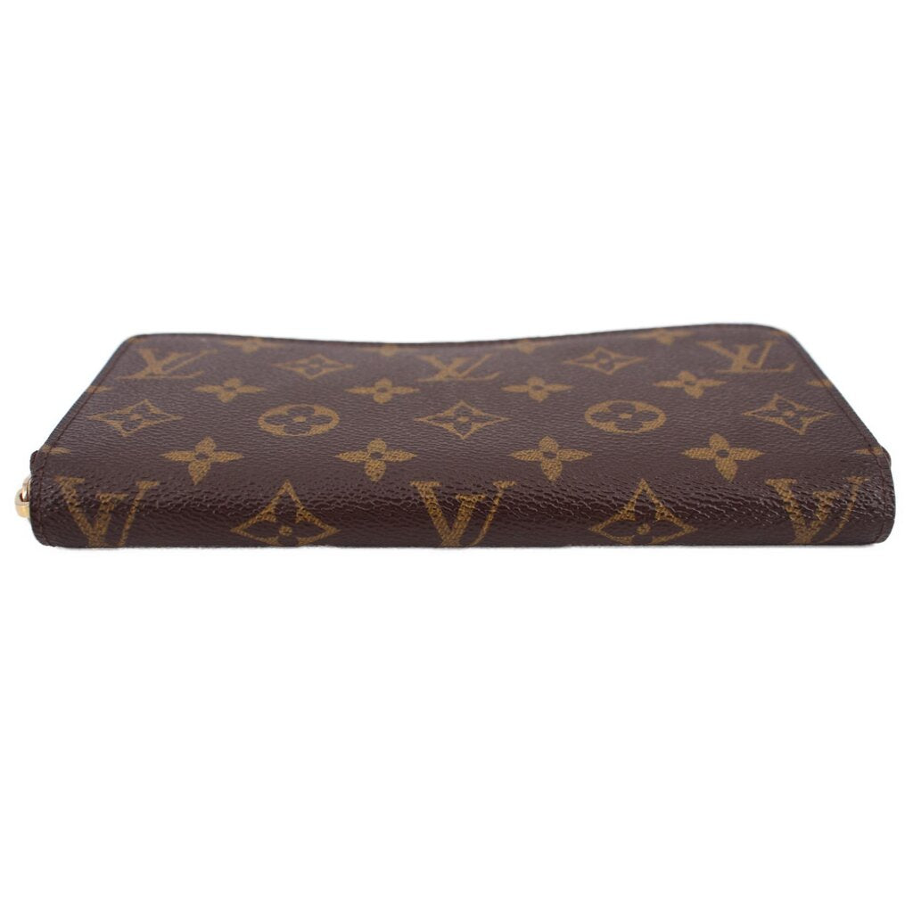 Brown monogram zip-around wallet laid flat with gold zipper edging.