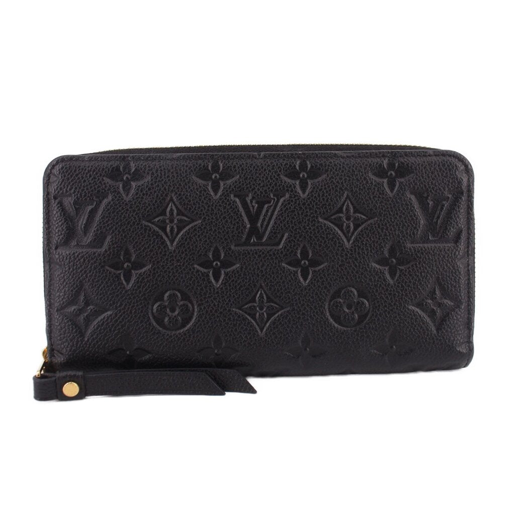 LOUIS VUITTON zip-around wallet in black embossed Monogram leather with zipper closure