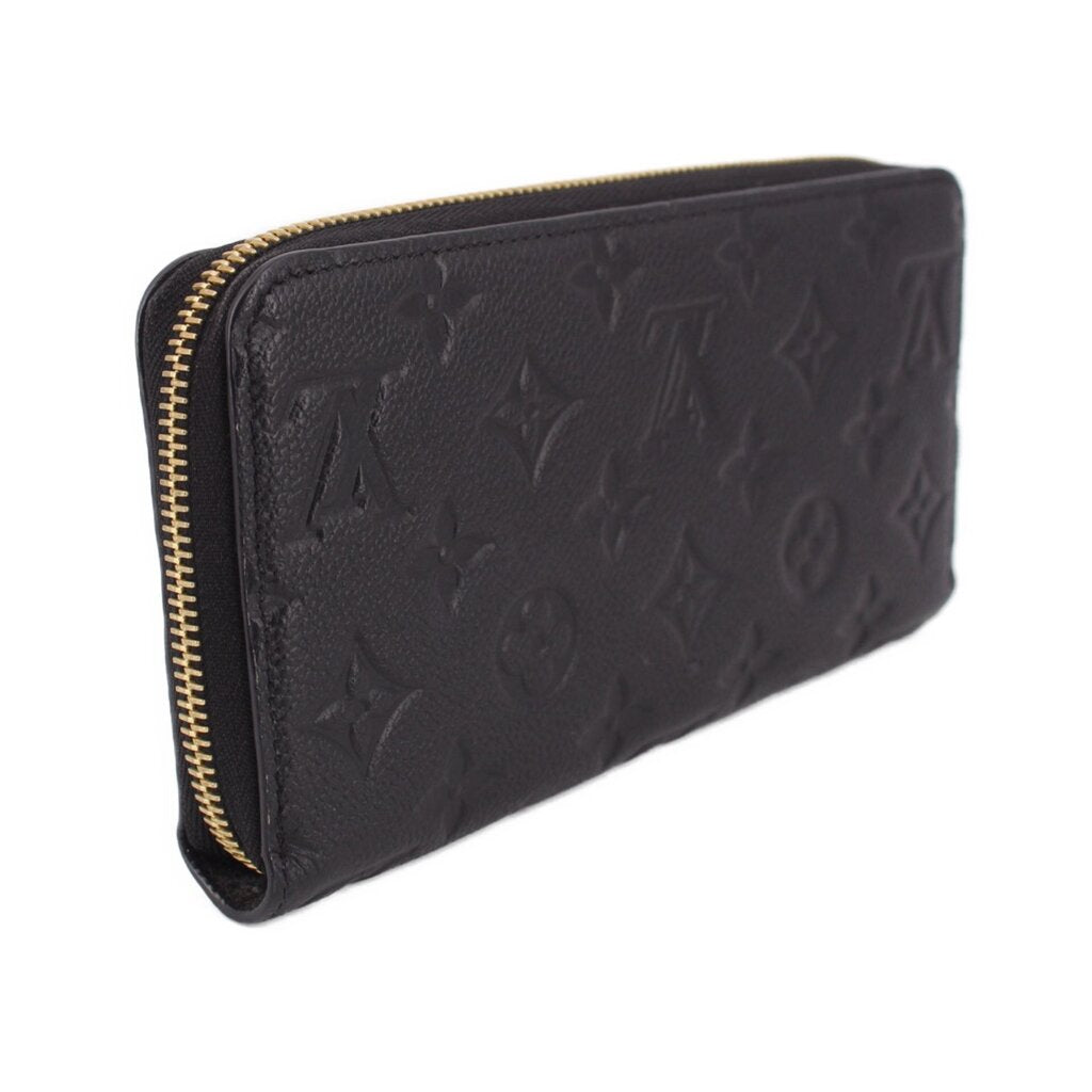 LOUIS VUITTON zip-around wallet angled view, black embossed leather and gold zipper