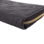 LOUIS VUITTON wallet close-up of gold zipper teeth on black embossed leather edge