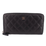 CHANEL zip-around wallet in black textured leather with CC logo and gold-tone zipper pull
