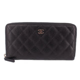 CHANEL zip-around wallet in black textured leather with CC logo and gold-tone zipper pull