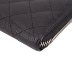 CHANEL black leather zip-around wallet corner close-up with stitched seams and zipper teeth