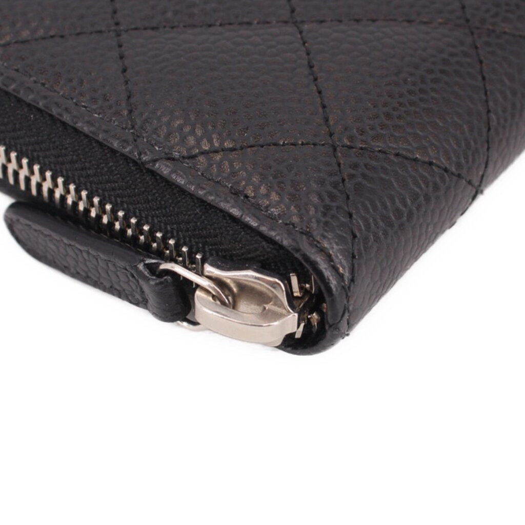 CHANEL black zip-around wallet corner close-up with zipper pull and metal hardware