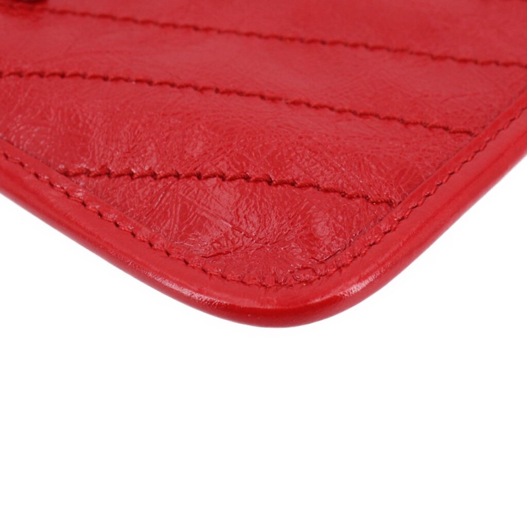 Red leather Niki pouch wallet corner with detailed edge stitching