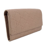 GUCCI taupe Continental wallet angled view with embossed GG monogram flap