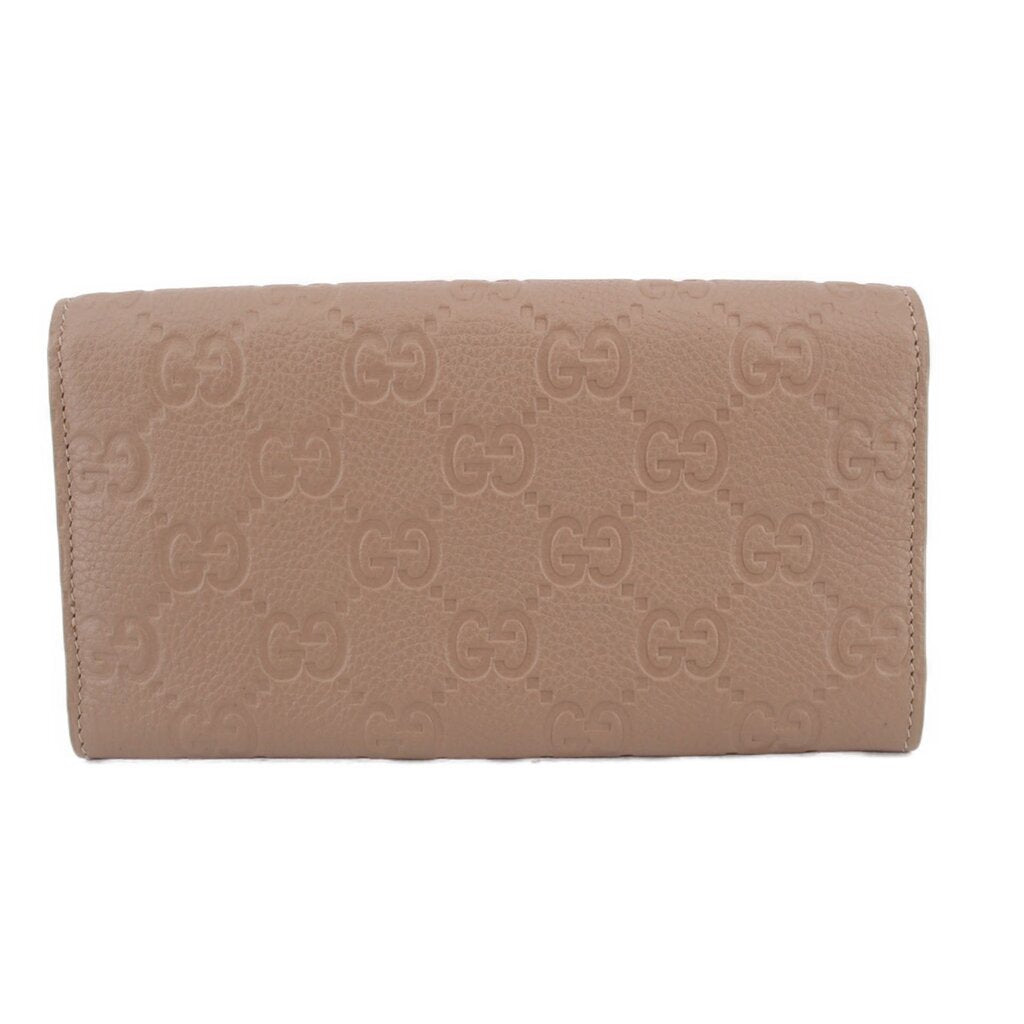 GUCCI taupe Continental wallet front view with repeating embossed GG pattern
