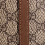 GG canvas with brown leather trim and visible edge stitching on dome bag