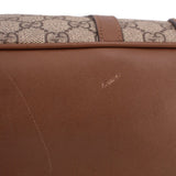 Brown leather panel with subtle diagonal seam on dome handle bag