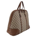 Brown GG canvas dome handle bag with zip top, leather side panel, and handles