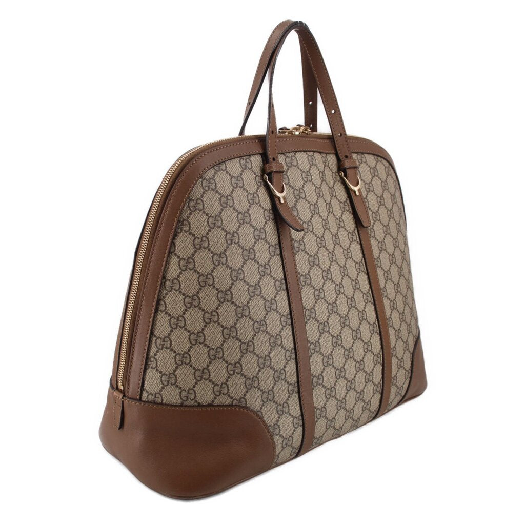 Brown GG canvas dome handle bag with zip top and curved leather bottom panels