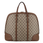 Brown GG canvas dome handle bag with front leather panels and metal handle hardware