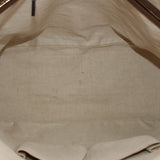 Cream fabric interior lining with seam detail inside dome handle bag
