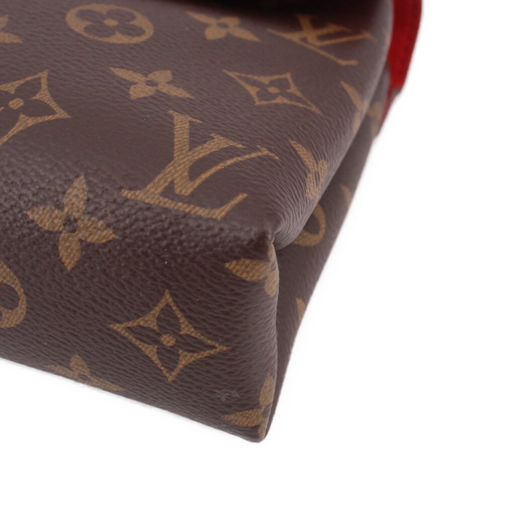 Close-up of brown monogram corner and textured canvas on crossbody bag