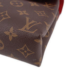 Close-up of brown monogram corner and textured canvas on crossbody bag