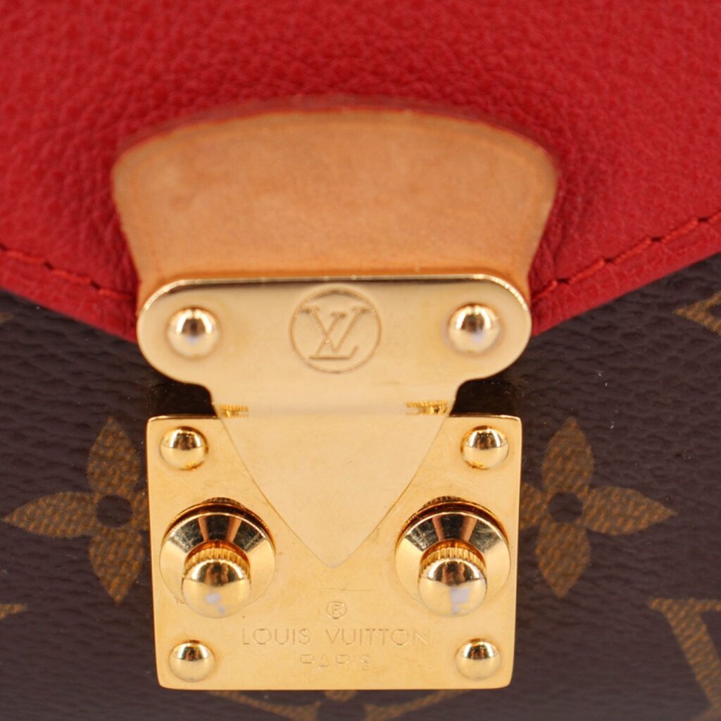 Gold-tone Louis Vuitton padlock clasp on red-and-brown monogram crossbody flap