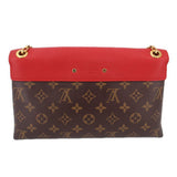 Small red flap crossbody bag with monogram canvas front and two gold-tone eyelets