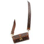 Monogram crossbody trunk bag with adjustable strap and gold-tone hardware