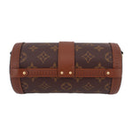 Monogram cylindrical trunk bag with front clasp and brown leather trim