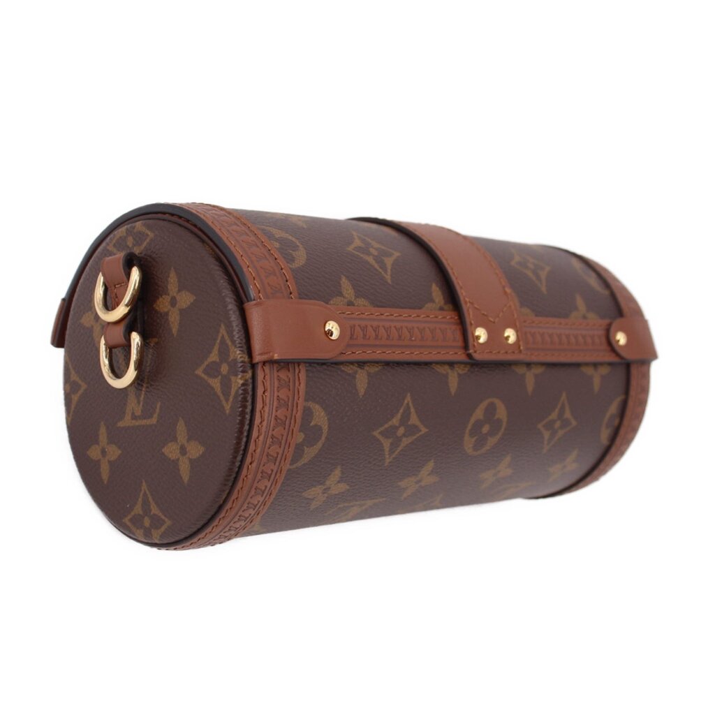 Side view of monogram crossbody trunk bag with gold hardware and curved flap