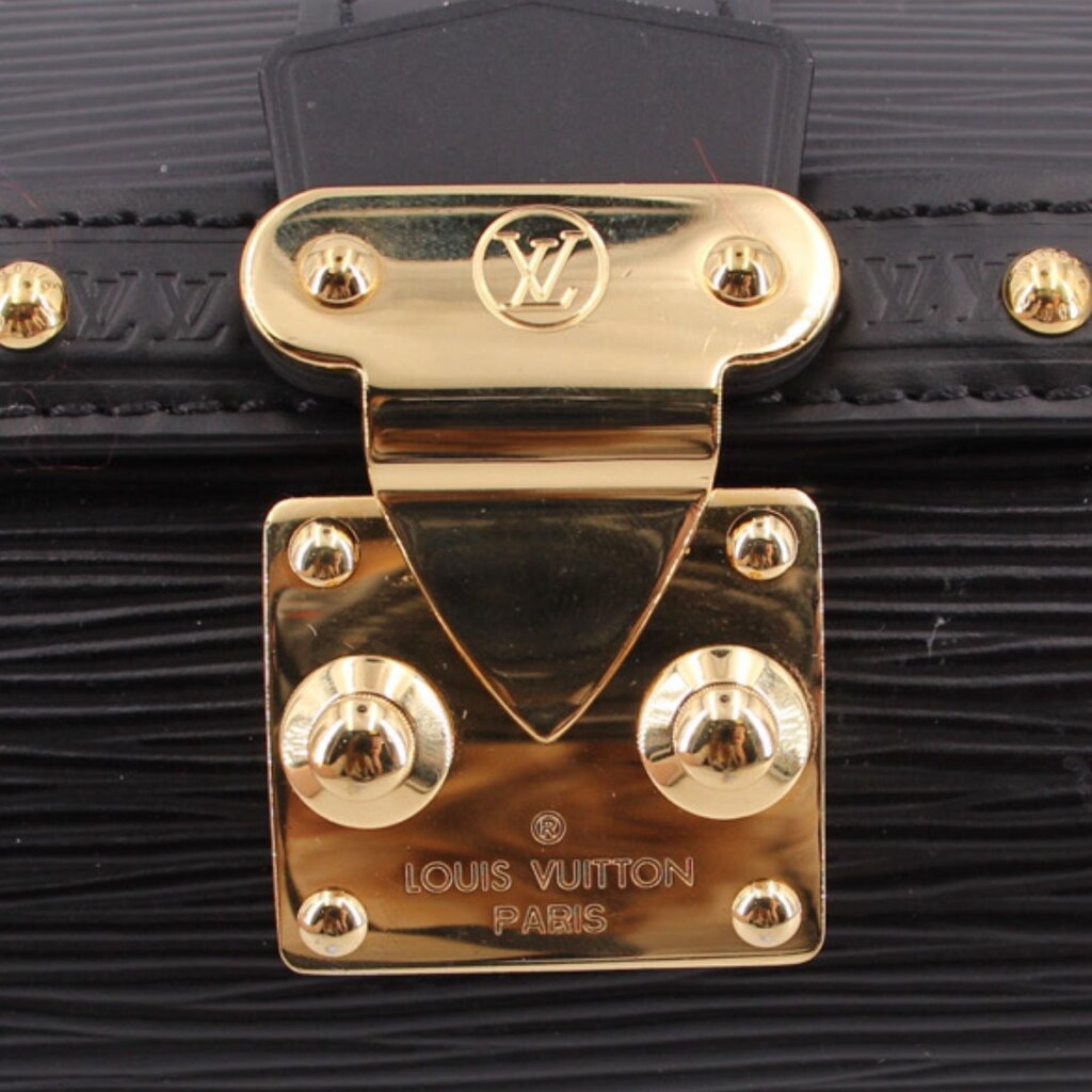 LOUIS VUITTON Papillon clasp close-up, gold-tone hardware with LV logo