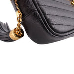 Saint Laurent mini Lou camera crossbody bag detail: gold tassel charm and zipper pull