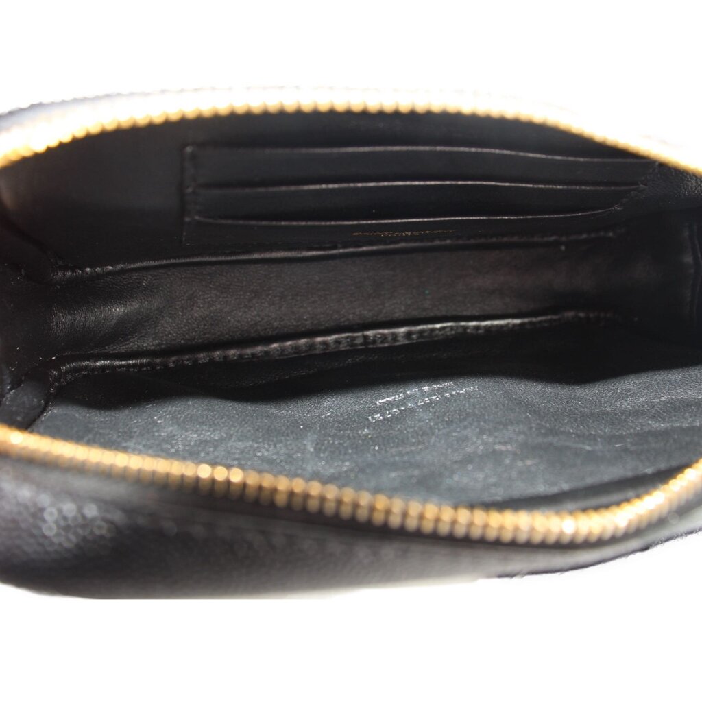 Saint Laurent mini Lou camera crossbody bag interior with black lining and gold zipper edge