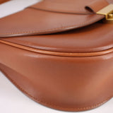 Cognac leather crossbody bag close-up of stitched seams and fold-over edge