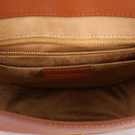 Cognac leather crossbody bag interior with zip pocket and VERONICA BEARD label