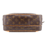 Monogram crossbody bag bottom view with stitched tan trim and flat base