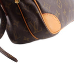 Monogram crossbody strap and tan corner leather detail close-up