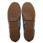 Blue denim loafers with tan rubber soles and embossed logo on heel