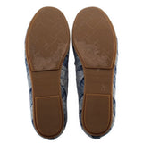 Blue denim loafers with tan rubber soles and embossed logo on heel