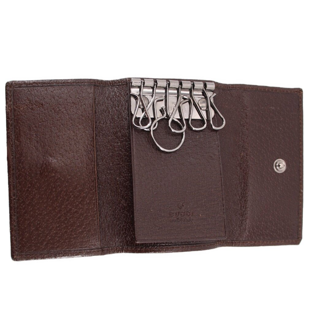Brown Gucci tri-fold key case interior with key hooks and snap button