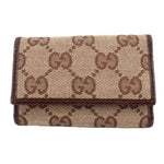 Brown Gucci tri-fold key case with GG monogram canvas and flap closure
