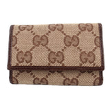 Brown Gucci tri-fold key case with GG monogram canvas and flap closure