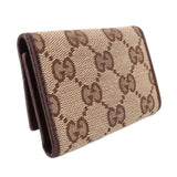 Brown Gucci tri-fold key case, angled view, GG monogram canvas and dark trim