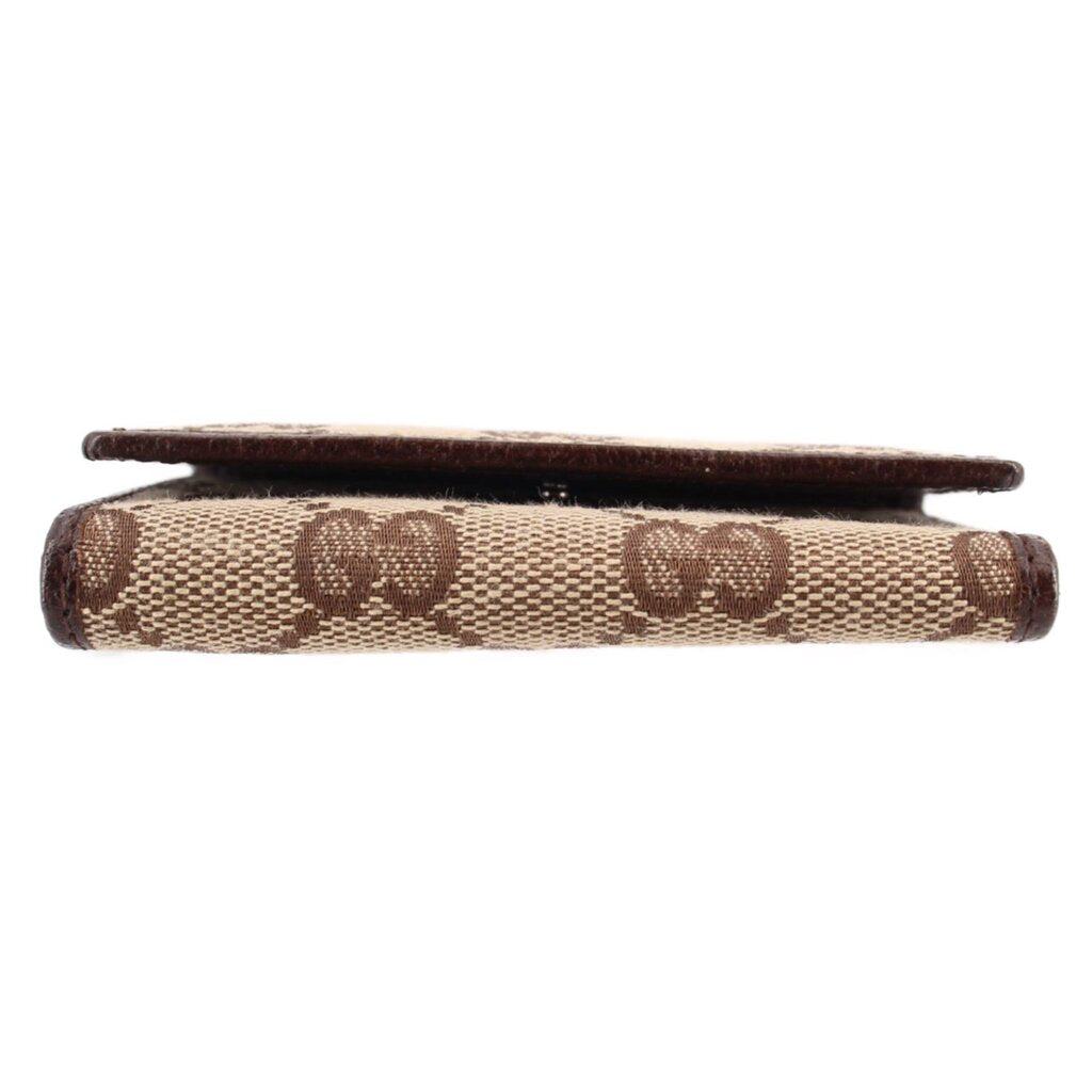 Brown Gucci tri-fold key case profile, GG monogram canvas with leather trim