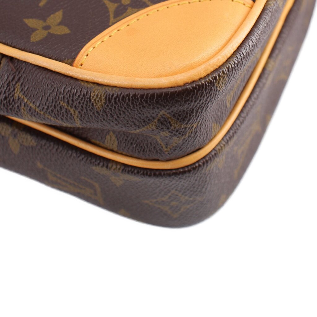 LOUIS VUITTON monogram crossbody bag corner close-up, tan piping and pebbled texture