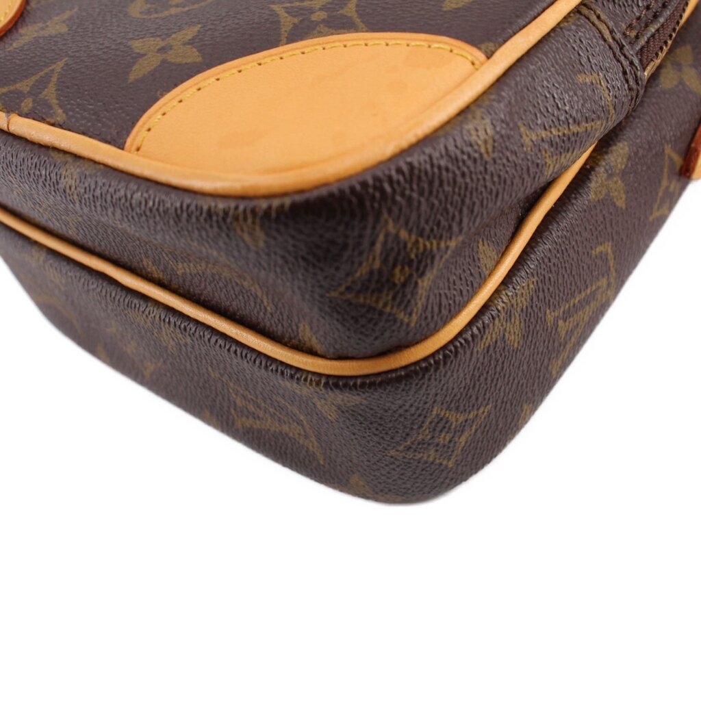 LOUIS VUITTON monogram crossbody bag bottom corner close-up, tan trim and rounded edge