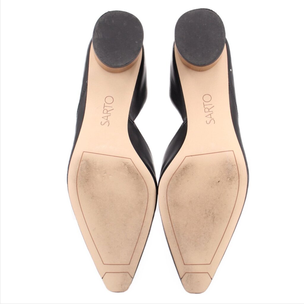 Bottom view of black leather heeled pumps with tan branded footbeds