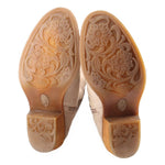 Beige boot outsoles with floral carved tread and rubber traction