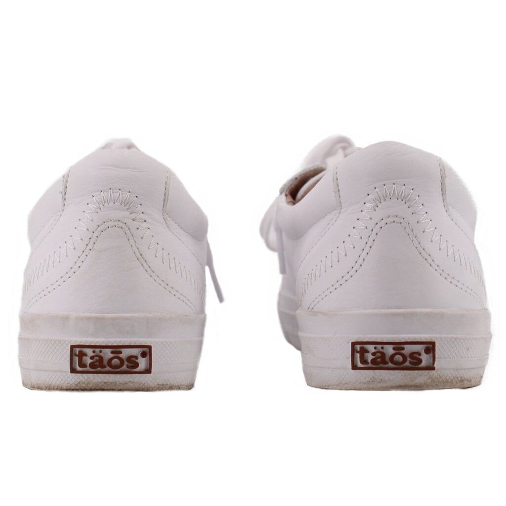 White leather sneakers with rear view and 'taos' logo heel tab