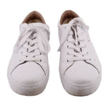 Pair of white leather sneakers, toe view with lace-up uppers