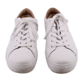 Pair of white leather sneakers, toe view with lace-up uppers